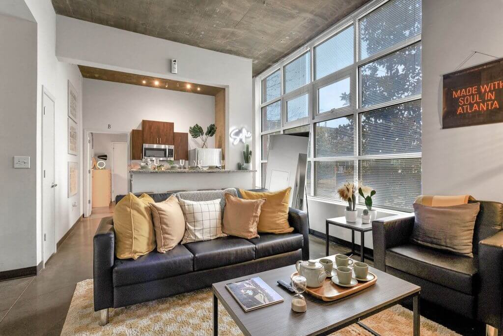 Couch with pillows and kitchen in the background