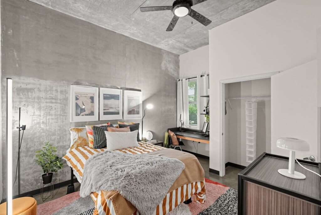 Industrial bedroom with integrated desk and large closet